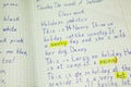 English text proofing in student notebook, words are marked yellow color