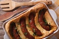 English toad in the hole into a baking dish close up. Horizontal Royalty Free Stock Photo