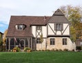 English Tudor Home with American Flag & Pumpkins Royalty Free Stock Photo