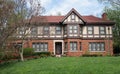 English Tudor Home with Red Spring Tulips