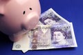 English twenty pound notes with piggy bank Royalty Free Stock Photo