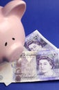 English twenty pound notes with piggy bank - vertical. Royalty Free Stock Photo