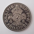 An English two shilling coin photographed against a white background