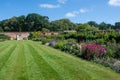 English walled garden with flowers and lawn Royalty Free Stock Photo