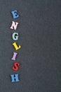 English word on black board background composed from colorful abc alphabet block wooden letters, copy space for ad text