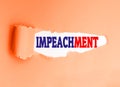 English word impeachment written on a torn paper