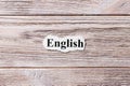English of the word on paper. concept. Words of english on a wooden background