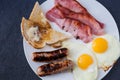 Englsih breakfast with bacon, pork and apple sausages Royalty Free Stock Photo