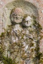 Engraved sculpture of saint on grave