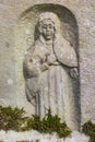 Engraved sculpture of saint on grave