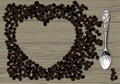 Engraved vintage color drawing of a heart shaped frame of coffee beans on wood textured background and retro spoon Royalty Free Stock Photo