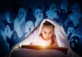 Engrossed little girl reading book in bed Royalty Free Stock Photo