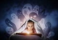 Engrossed little girl reading book in bed Royalty Free Stock Photo