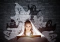 Engrossed little girl reading book in bed Royalty Free Stock Photo