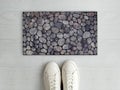 Beautiful Solid Pebble Stone Pattern entry designer doormat with white sneaker shoes