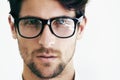 Enhance your vision. Closeup portrait of a handsome male wearing black rimmed glasses next to copyspace.