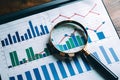 Enhancing data analysis with visuals and scrutiny using laptop and magnifying glass