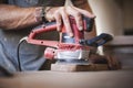 Enhancing Wood's Beauty: Expert Hand Polishing with random Orbital Sander