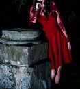 Enigmatic Elegance: A Mysterious Gothic Tale of a Slender Woman in a Intensely Red Dress Royalty Free Stock Photo