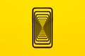 Enigmatic surrealistic optical illusion. Close-up modern smartphone isolated on yellow background.