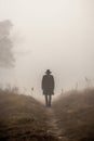 mysterious farmer in a foggy rural landscape.