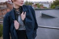 Enigmatic young woman wearing in man`s jacket