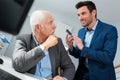 Enior and young businessmen discussing at table together Royalty Free Stock Photo