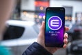 Enjin ENJ coin symbol. Trade with cryptocurrency, digital and virtual money, mobile banking. Hand with smartphone