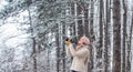 Enjoy beauty of snow scenery through photos. Woman photographer with professional camera. Inspiration to create