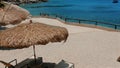 Enjoy day at beach in Mediterranean. Beach chair and umbrellas in tropical resort Royalty Free Stock Photo