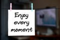 Enjoy every moment. Note is written on a white sticker that hang