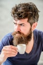 Enjoy hot drink. Hipster drinking fresh brewed coffee. Man with beard and mustache and espresso cup. Bearded guy consume Royalty Free Stock Photo