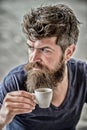 Enjoy hot drink. Hipster drinking fresh brewed coffee. Man with beard and mustache and espresso cup. Bearded guy consume Royalty Free Stock Photo