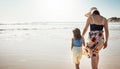 Enjoy the little moments. Rear view shot of a mother and her little daughter bonding together at the beach. Royalty Free Stock Photo