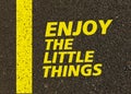 Enjoy the little things written on the road. Royalty Free Stock Photo