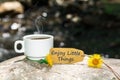 Enjoy little things text with coffee cup