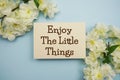 Enjoy the little things text message top view on blue background Royalty Free Stock Photo