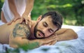 Enjoy in massage at nature. Close up image of young men. Royalty Free Stock Photo