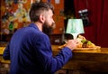 Enjoy meal. Restaurant client. Hipster formal suit sit at bar counter. Man received meal with fried potato fish sticks