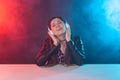 Enjoy, meloman and people concept - young woman with dreadlocks listening to the music, portrait over the dark Royalty Free Stock Photo