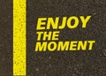 Enjoy the moment written on the road. Royalty Free Stock Photo