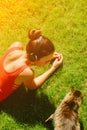 enjoy the music, top view of young brunette woman in red shirt, wearing headphones, looking at cat Royalty Free Stock Photo