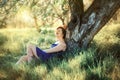 Enjoy Nature. Healthy Smiling Girl in the Spring Park. Sunny day. Outdoor portrait of beautiful young 30 years old woman relaxing Royalty Free Stock Photo