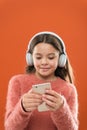 Enjoy perfect sound. Best music apps for free. Girl child listen music modern headphones and smartphone. Listen for free