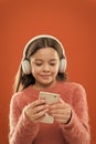 Enjoy perfect sound. Best music apps for free. Girl child listen music modern headphones and smartphone. Listen for free