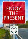 Enjoy the present red sign board Royalty Free Stock Photo