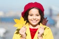 Enjoy season. Little girl adore autumn season. Kid cute face hold maple leaves. Small girl wear fall outfit outdoors