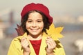 Enjoy season. Little girl adore autumn season. Kid cute face hold maple leaves. Small girl wear fall outfit outdoors