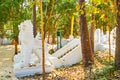 White chinthes in lush garden, Shwethalyaung Buddha Temple, Bago, Myanmar Royalty Free Stock Photo