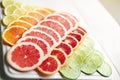 Enjoy some of lifes juicy delights. a variety of citrus fruits cut into slices on a plate.